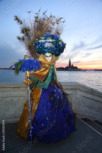 Venice Carnival masked Lady with peacock feather in sunset light © Adi