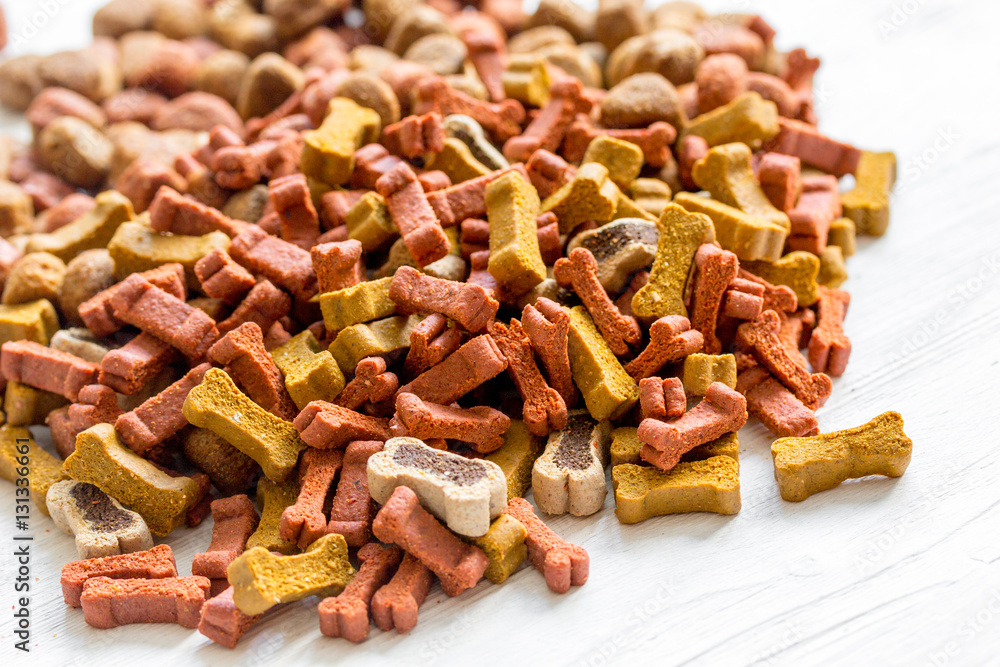 dry dog food in bulk on wooden background close up dry dog food in bulk on wooden background close up