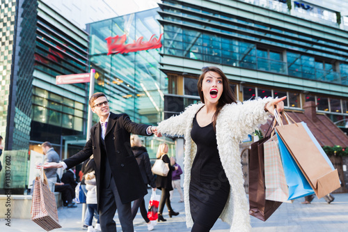 Couple with a shopping bags having an argument outdoors
