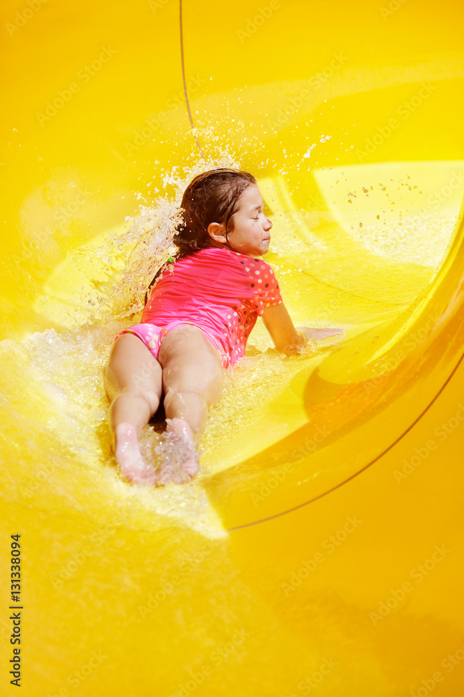Young girl in water slideYoung girl sliding feet first with eyes