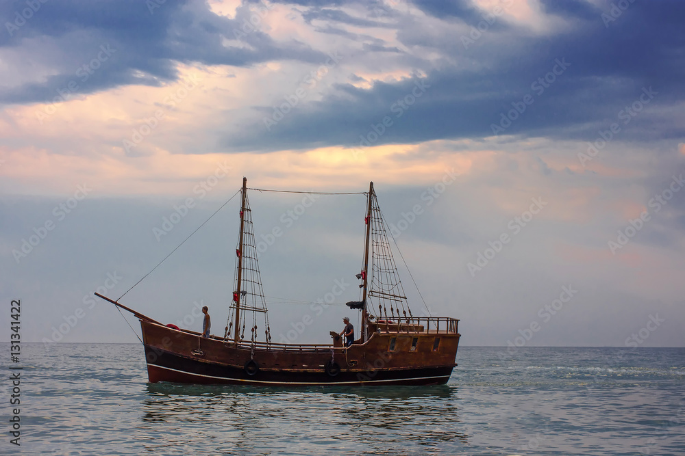 Wooden boat on a sunset background  