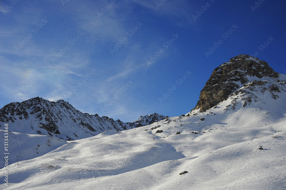 scenic view of snow mountains and ski resort in Switzerland Europe on a cold sunny day