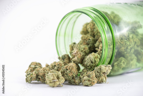 Detail of cannabis buds (ob reaper strain) on green glass jar is