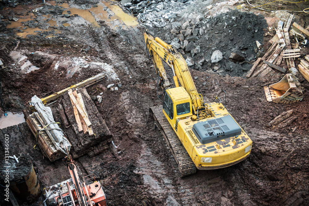 Yellow excavator digging on construction site. . Yellow excavator digging on construction site. .