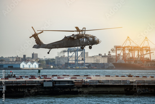 Foto Military helicopter landing on heliport in New York City.