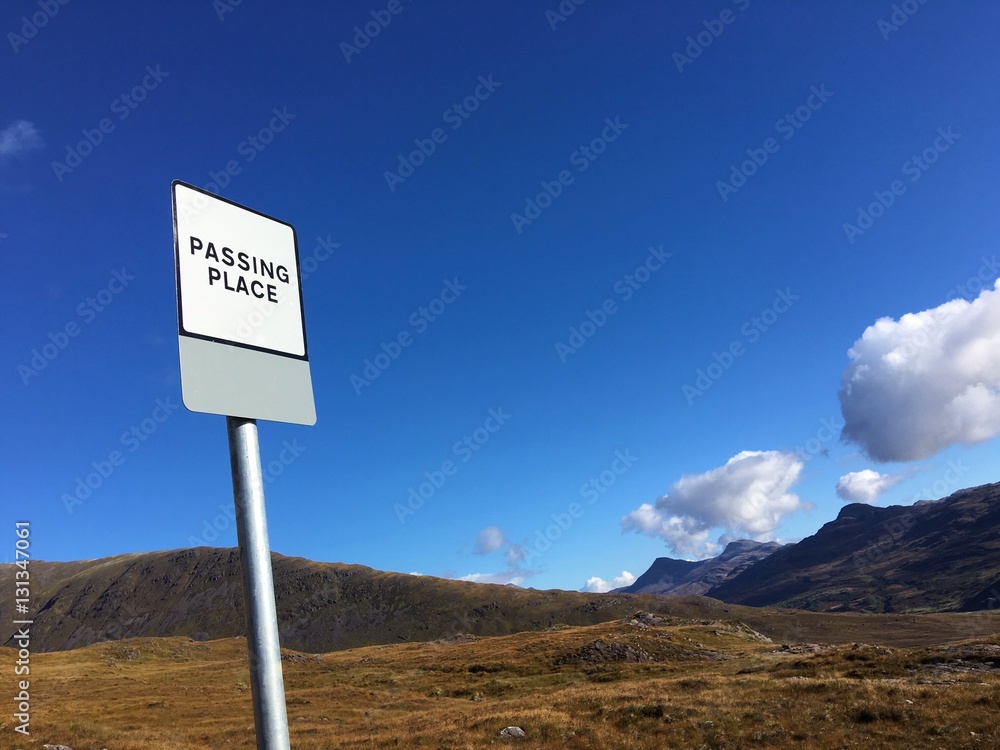 A Passing Place sign in the historic pass through the Applecross Peninsula, Wester Ross, Highland Region, Scotland, UK. A Passing Place sign in the historic pass through the Applecross Peninsula, Wester Ross, Highland Region, Scotland, UK.