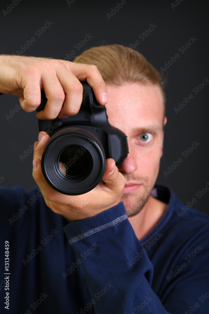 Handsome photographer with camera,isolated on black Handsome photographer with camera,isolated on black
