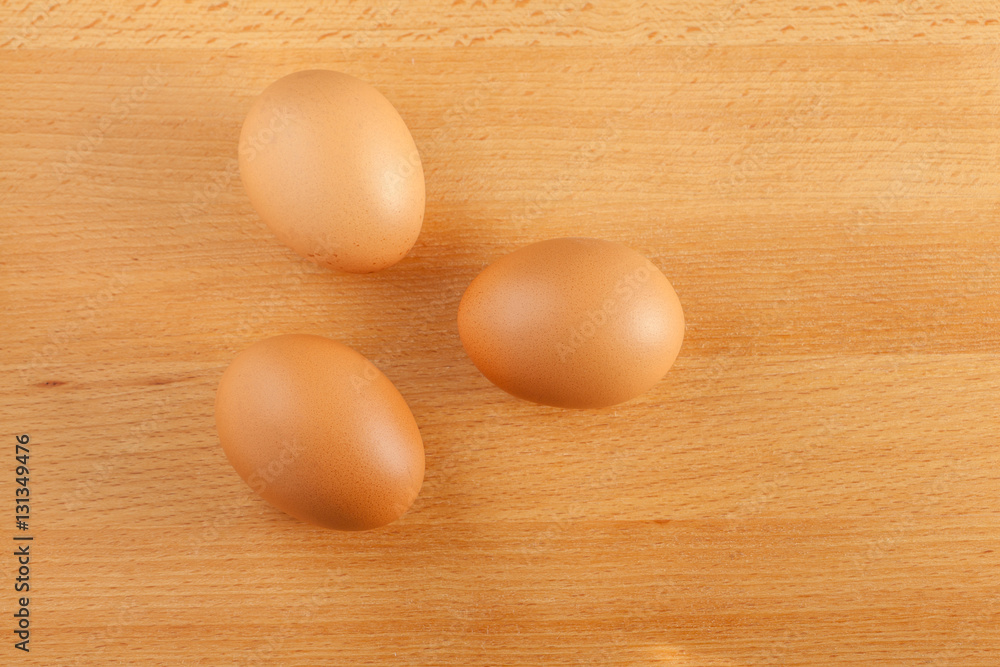 Home cooking concept, fresh organic eggs on wooden board backgro Home cooking concept, fresh organic eggs on wooden board backgro