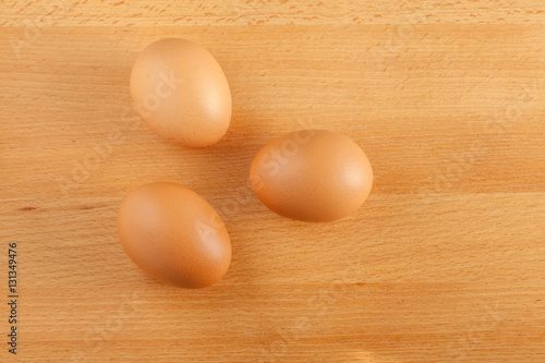 Home cooking concept, fresh organic eggs on wooden board backgro