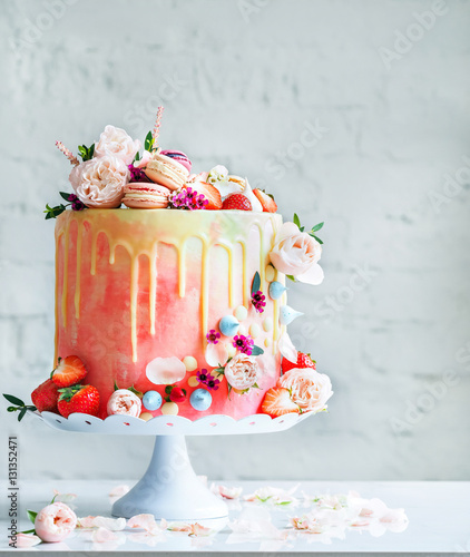 Wedding cake with flowers macarons and blueberries