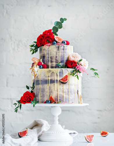 Wedding cake with flowers, figs, macarons and blueberries