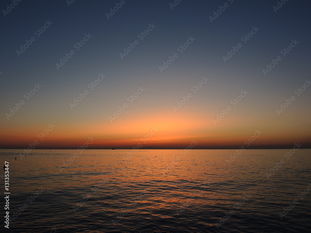 Fiery sunrise at Italian beach. Summer season. Emilia Romagna region. Adriatic sea. Italy