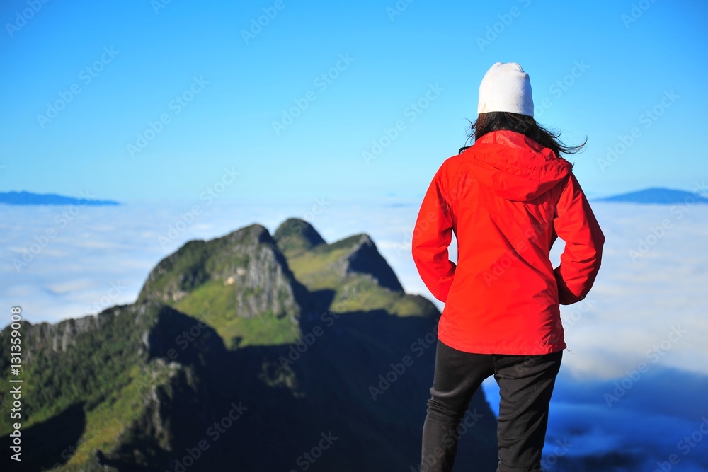Young Woman on Mountain Peaks