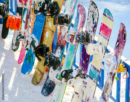several snowboards are about fencing