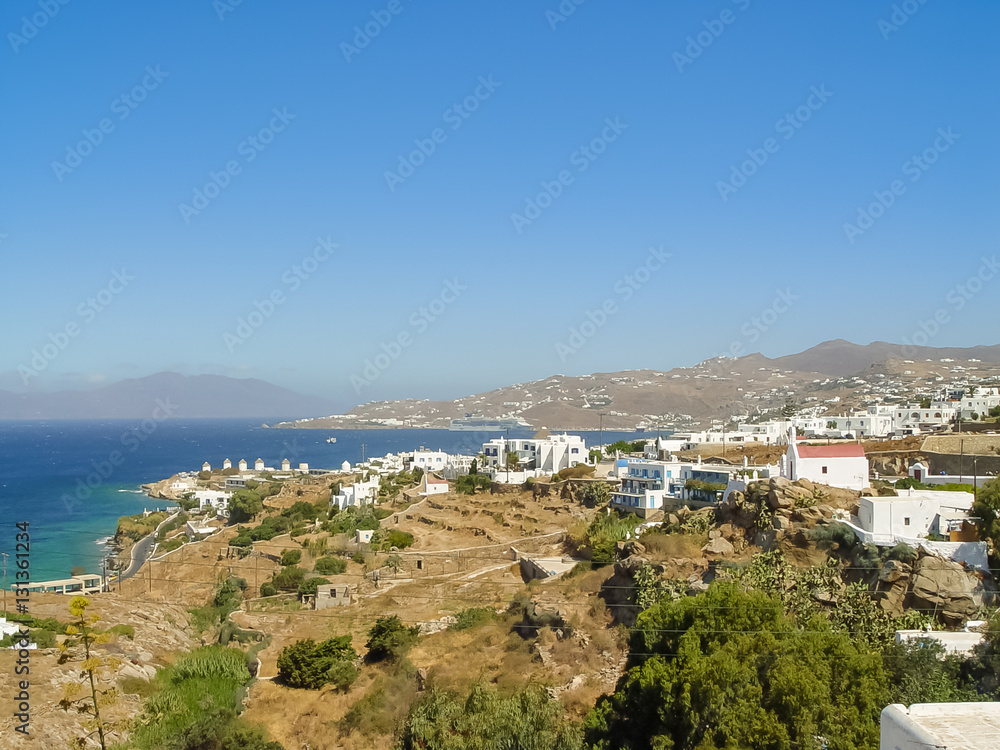 View of Mykonos port with boats and famous windmills