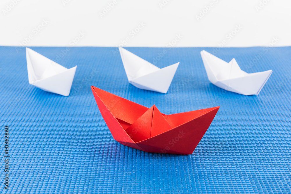 red paper ship leading among white red paper ship leading among white