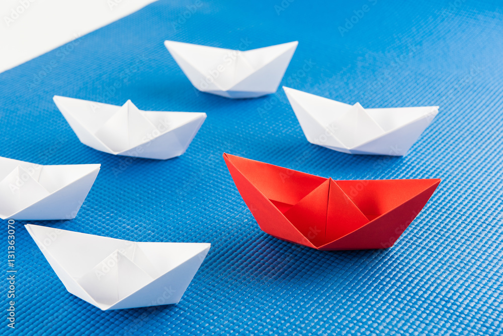 red paper ship leading among white red paper ship leading among white
