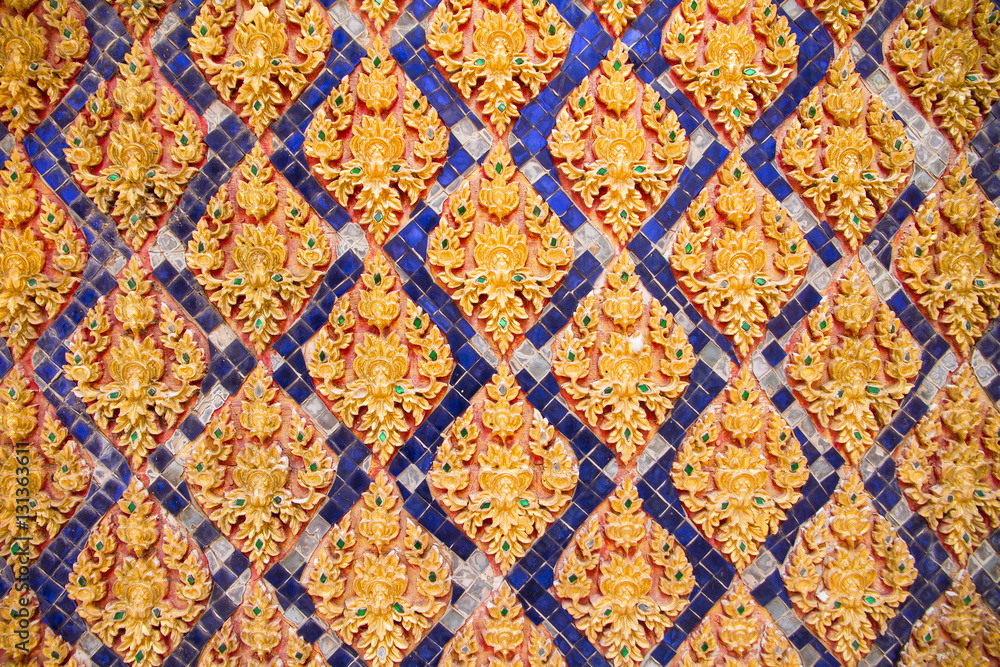 Traditional Thai style stucco on the wall of church in temple, T Traditional Thai style stucco on the wall of church in temple, T