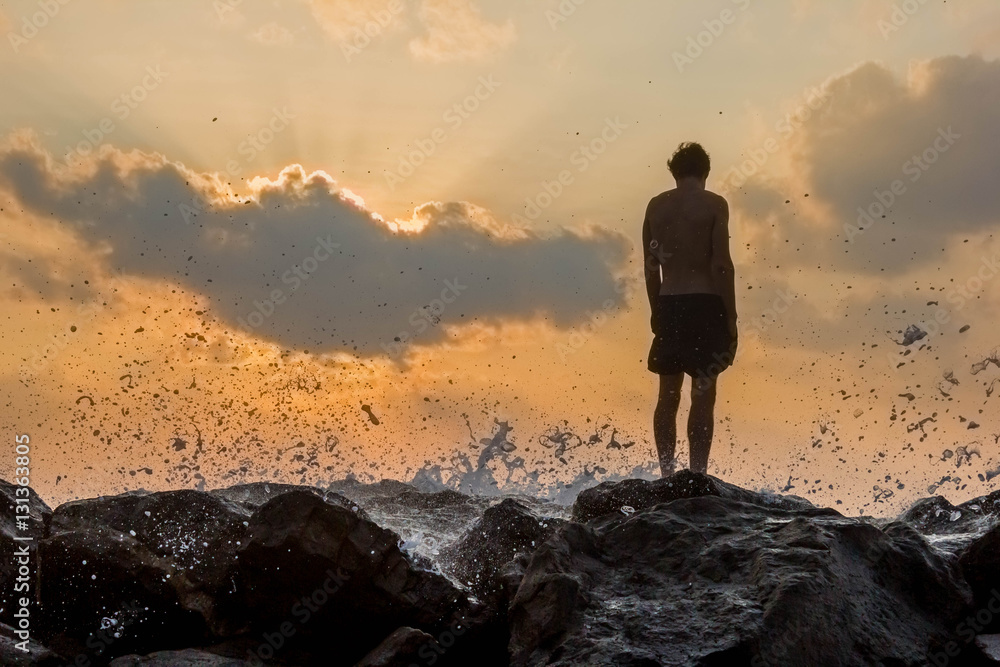 person standing on rocks seaside sunset silhouette frontback lig person standing on rocks seaside sunset silhouette frontback lig