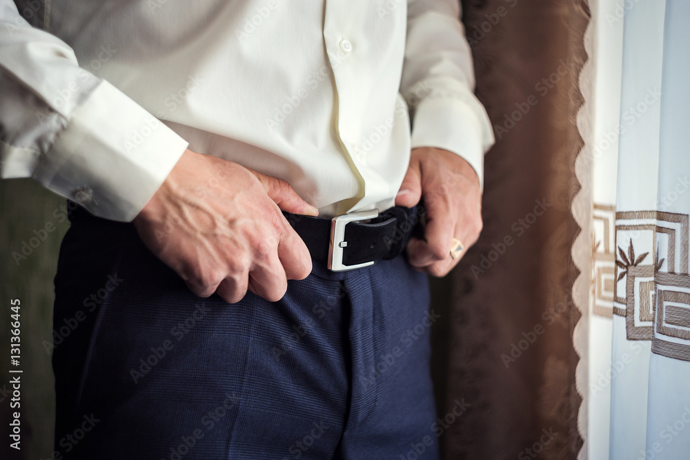 man putting on a belt, Businessman, Politician, man's style, male hands closeup, American businessman, European businessman, a businessman from Asia, People, business, fashion and clothing concept man putting on a belt, Businessman, Politician, man's style, male hands closeup, American businessman, European businessman, a businessman from Asia, People, business, fashion and clothing concept