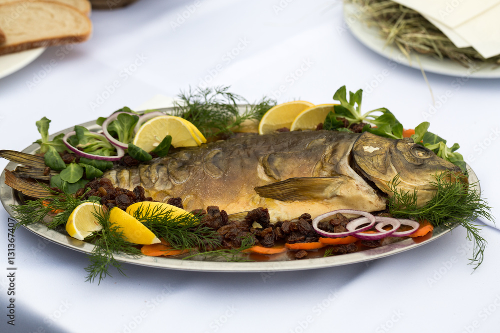 carp with lemon, dill and raisins on plate carp with lemon, dill and raisins on plate