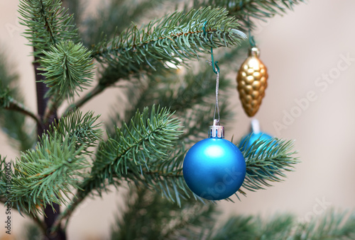 Decorated Christmas tree, vivid blue sparkling ball,selective focus photo