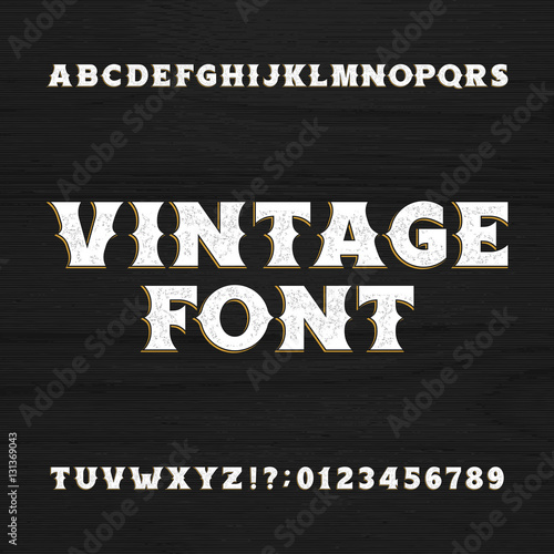 Vintage typeface. Retro distressed alphabet font on a wooden background. Wild west bold letters and numbers. Rough vector typeset for labels, headlines, posters etc.