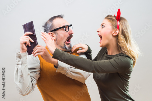 Fotografi Nerdy man is trying to hide money from his wife because she want to spend it all