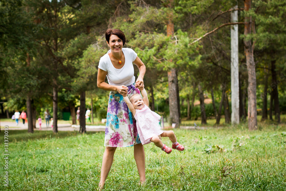 Fototapeta premium Small cute baby and nice mom outdoors