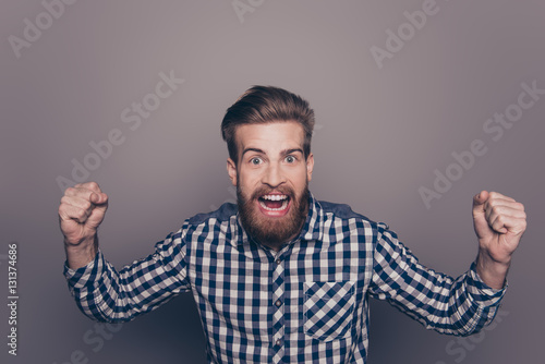 portrait of screaming man raised hands with fists and open mouth