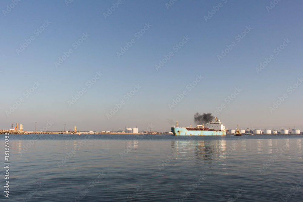 Rural marine landscape. Chemical Vessel leaving the port