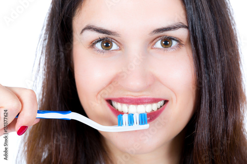 Young woman face, brushing teeth isolated on white background
