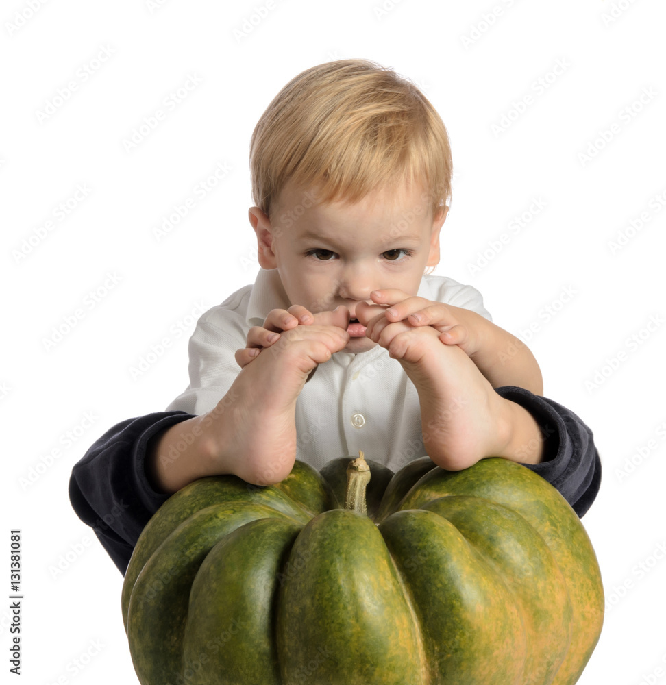 Fototapeta premium Cute boy sitting with pumpkin