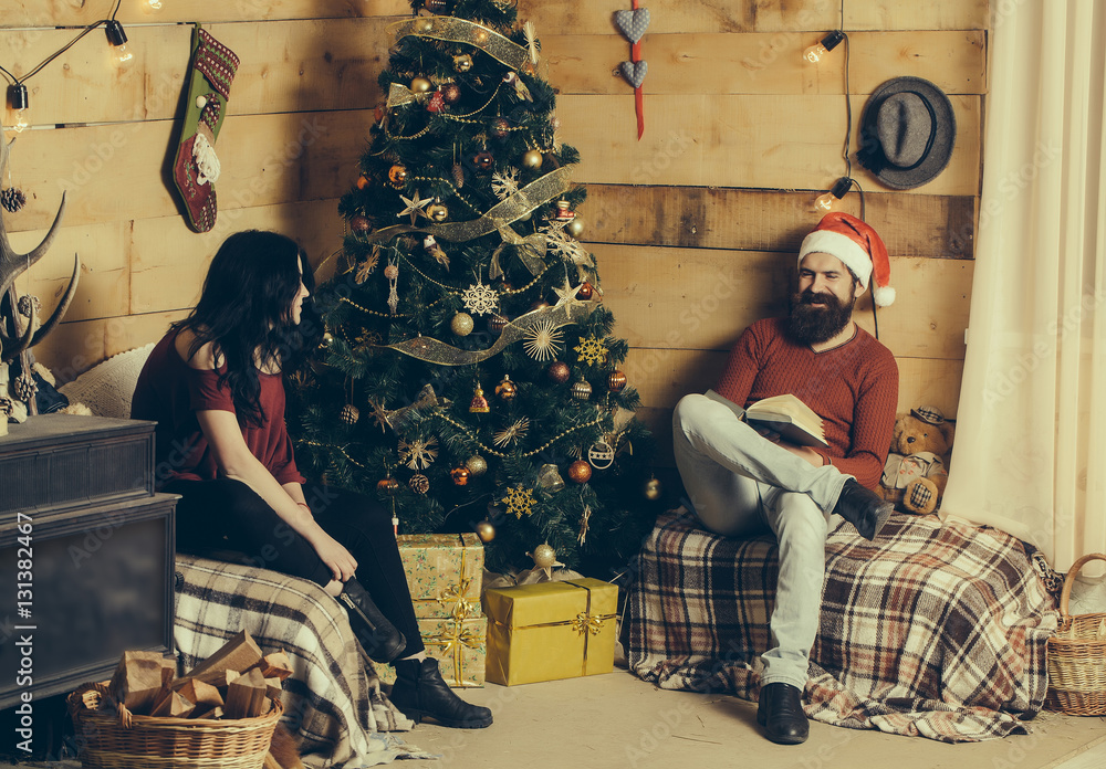 Fototapeta premium christmas couple at decorated tree