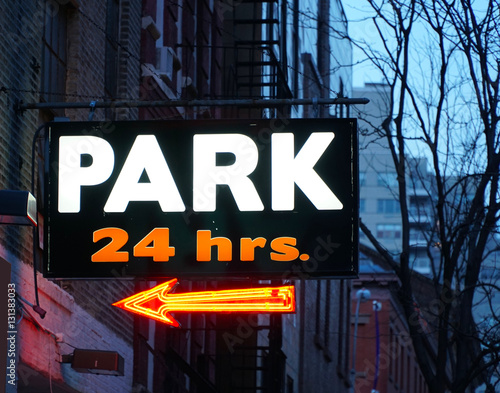 Obraz na płótnie 24 hour parking garage sign in neon colors in Manhattan village New York City. Expensive rates to park cars and vehicles any time of day w salonie