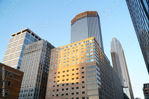 Look up view at downtown Minneapolis Minnesota skyscrapers. Center location for banking institution headquarters in north midwest at sunset