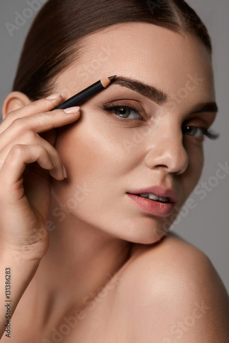 Beautiful Sexy Woman Contouring Eyebrows. Glamorous Makeup