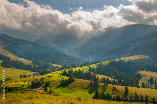 In the Carpathian Mountains the sun's rays shine on the mountains and forest in a village in the Carpathians Podobovets. Transcarpathia. Haystack in the Carpathian Mountains, Ukraine.