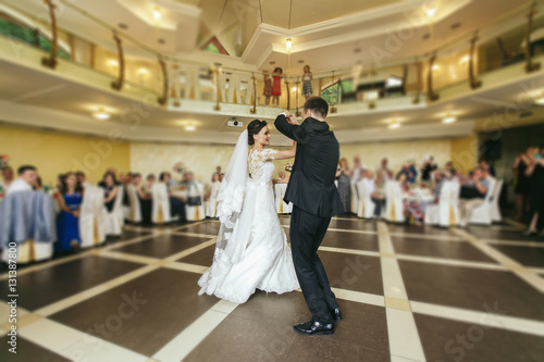 Romantic couple of newlyweds first dance at wedding reception