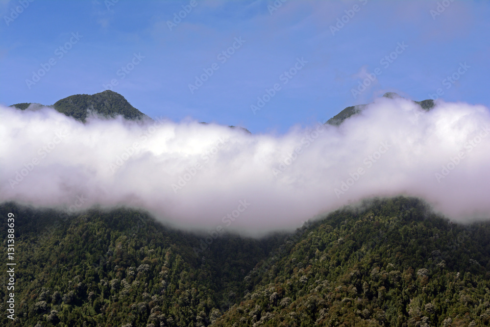 high mountains of the range with clouds in between