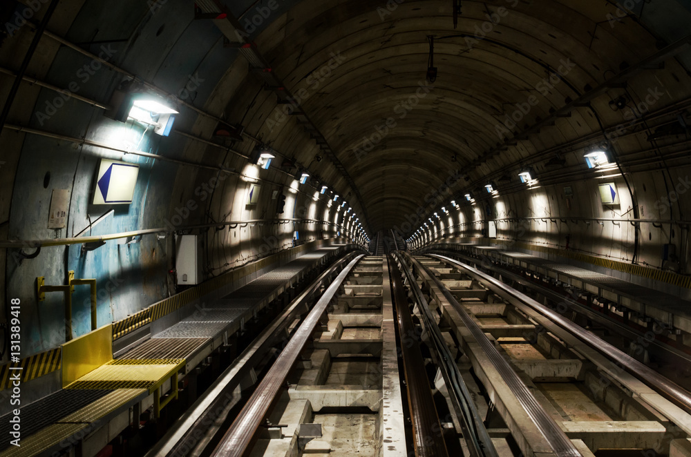 Metro subway of Turin (Italy), dark tunnel with rails seen from the train Metro subway of Turin (Italy), dark tunnel with rails seen from the train