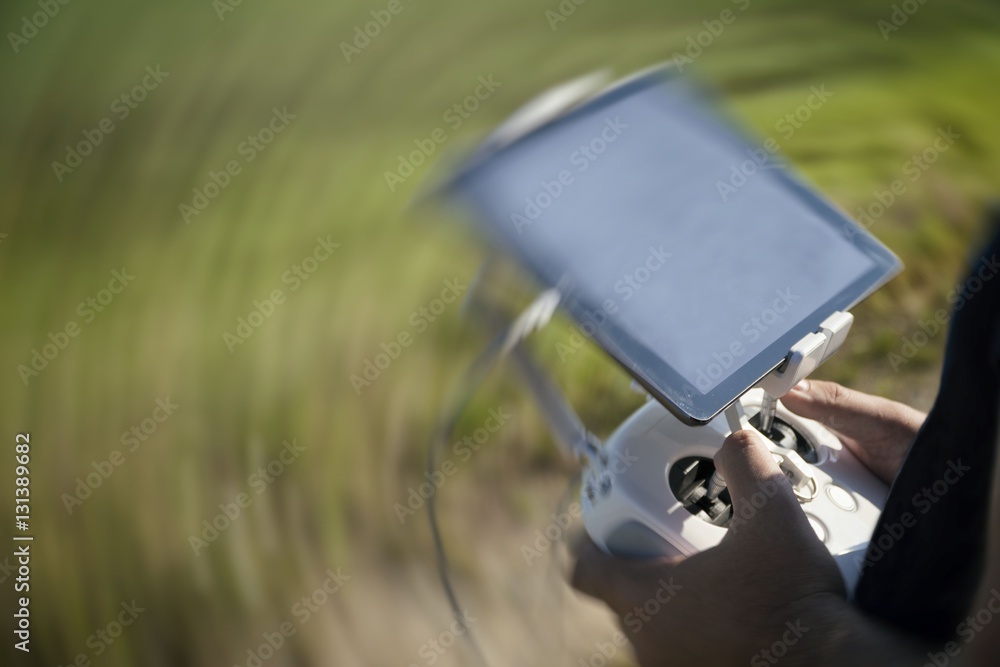 Drone remote control in hand man.Man operating of flying drone Drone remote control in hand man.Man operating of flying drone