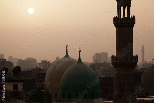 Sunset in dusty Cairo with mosque and minaret