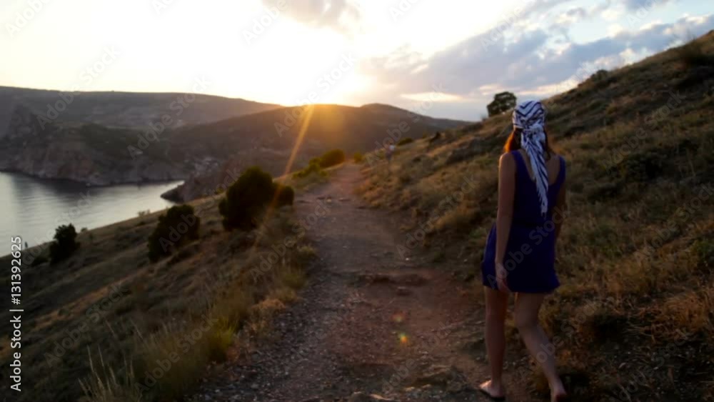girl in the headscarf goes to the sunset behind the mountain girl in the headscarf goes to the sunset behind the mountain