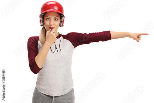 Photography Female baseball coach blowing a whistle and pointing right