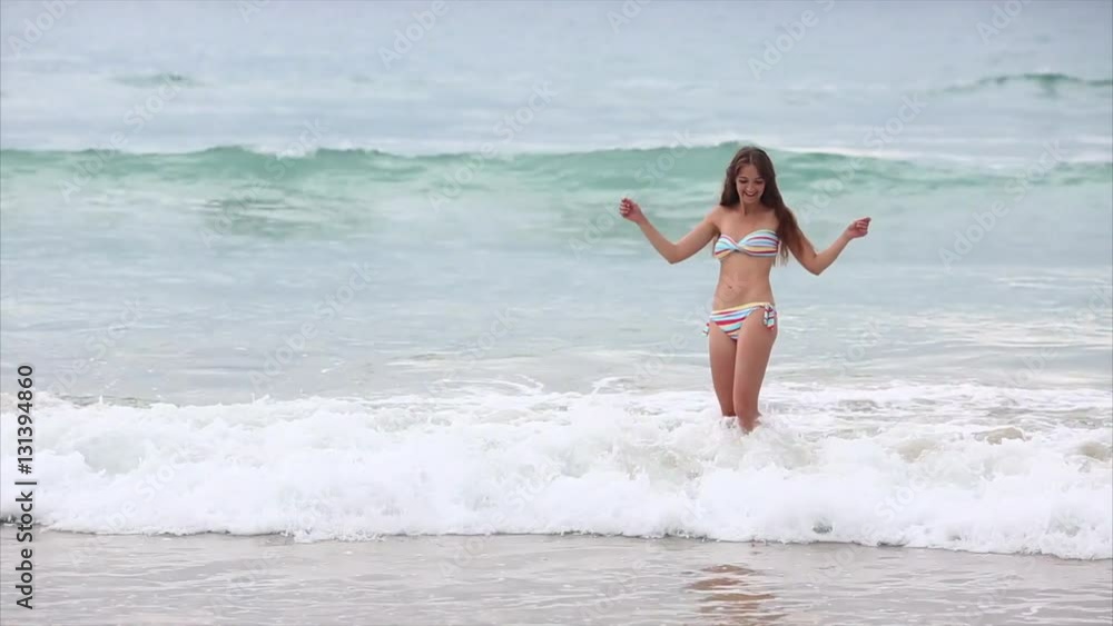 Woman in Colorful Swimsuit Posing on the Beach Woman in Colorful Swimsuit Posing on the Beach