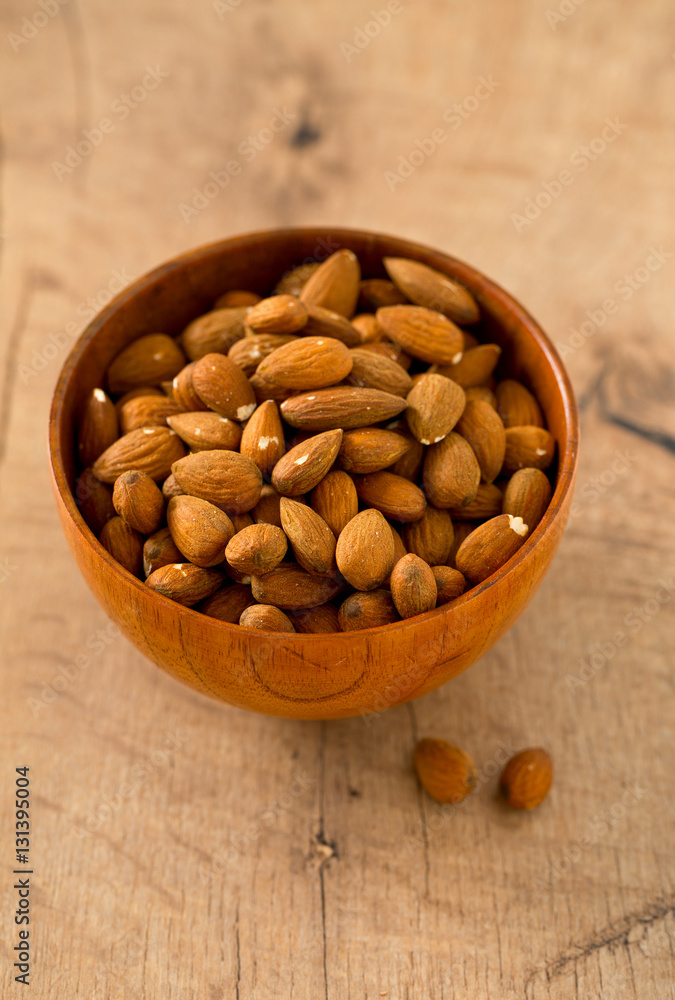 almonds on wooden surface almonds on wooden surface