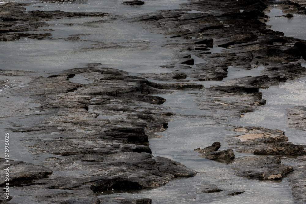 Dark rocks formations along the shoreline in western Galilee Dark rocks formations along the shoreline in western Galilee