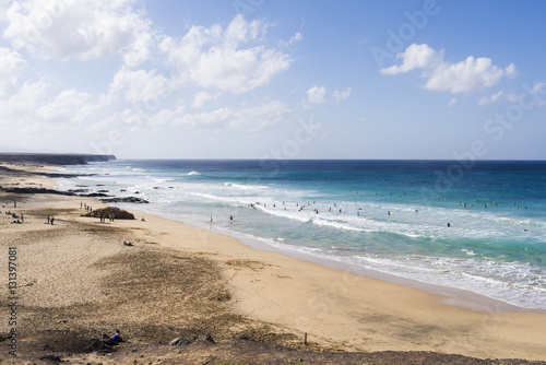 Surfer at Playa Moro, Corralejo, Fuerteventura a popular beach b