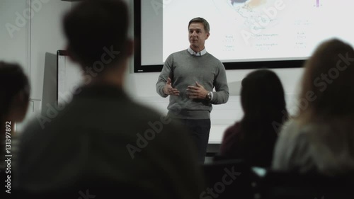 Professor teaching with projector photo